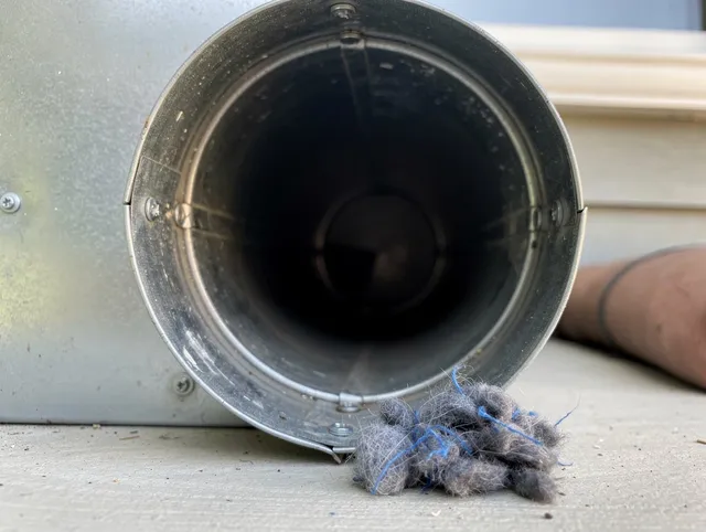 Stamford Dryer Vent Cleaning technician using specialized equipment to clear severe dryer vent blockage in Stamford